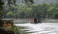 Des sauveteurs à bord d'un bateau pneumatique sur le fleuve Guadalupe recherchent des personnes portées disparues après les inondations subites à Hunt, dans l'Etat américain du Texas, le 6 juillet 2025 ( AFP / RONALDO SCHEMIDT )