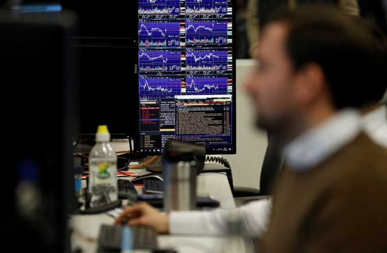 Des traders financiers travaillent à leurs bureaux chez CMC Markets