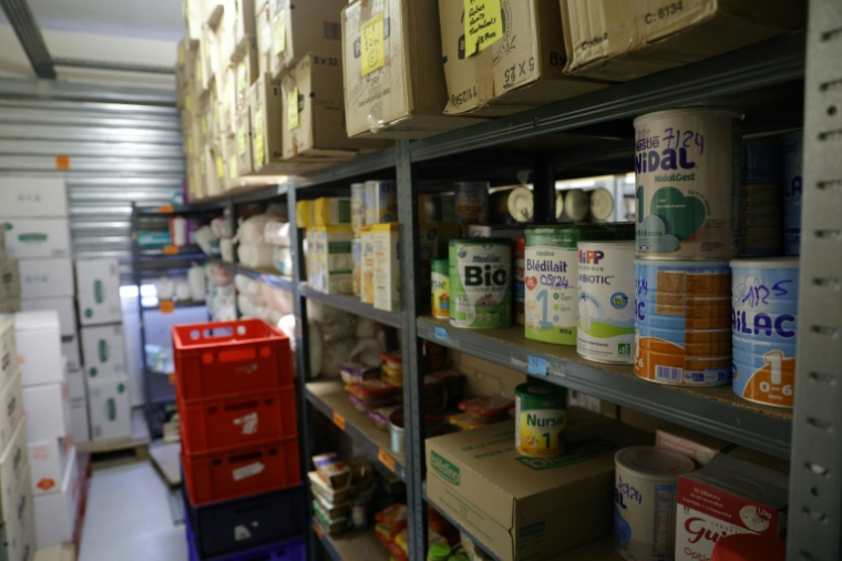 Du lait pour enfants sur les étagères d'un centre des Restos du coeur, à Asnières-sur-Seine, au nord de Paris, le 21 novembre 2023 ( AFP / Geoffroy VAN DER HASSELT )