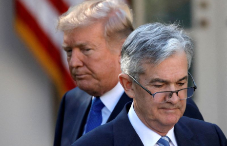 FILE PHOTO: U.S. President Donald Trump looks on as Jerome Powell, his nominee at the time to lead the Fed, moves to the podium at the White House