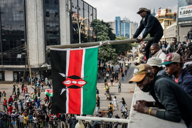 Un homme agite un drapeau kényan lors de la manifestation du 25 juin 2025 dans le centre-ville de Nairobi ( AFP / Luis TATO )